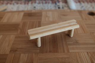 A small bench constructed from chopsticks.