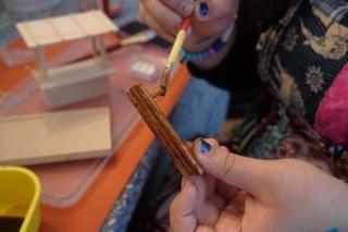 Wooden pieces being stained a deep brown.