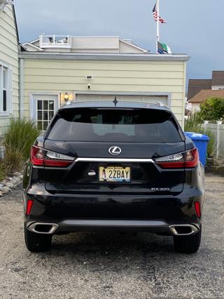 Sake bottles lined up on a shelf, with the punny name “Heavensake”.