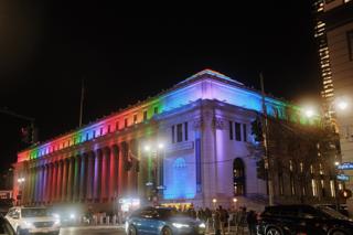 Moynihan Train Station lit up in Pride colors.