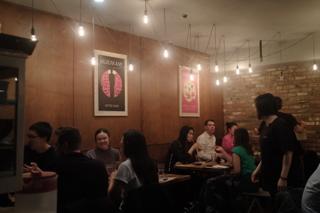 Diners in a small underground sushi restaurant.