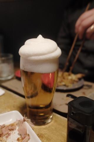 A Kirin lager topped with frozen foamy head.