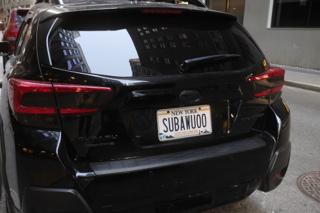 A Subaru with a vanity plate reading “SUBAWUOO”.