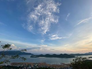 Islands in a bay under sparse clouds and fading light