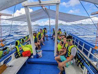 A family on an outrigger boat.
