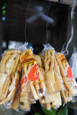 A bundle of bags of kropek hung from a market stall.