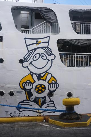A cartoon sailor character painted on the side of a passenger ferry.