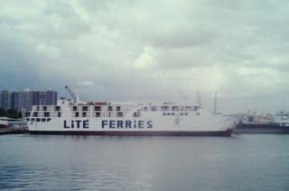 A ferry in the distance with “Lite Ferries” painted on the side