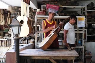 A man assembles a guitar.