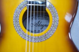 A shot of the interior of a guitar, reading “Handmade in the Philippines”.