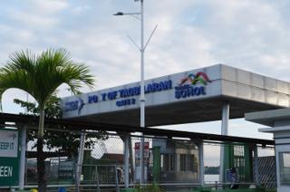 A sign above an entry gate to a port, with a missing letter so it reads “Pot of Tagbilaran”.