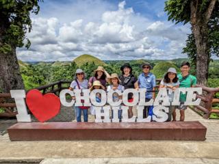 A series of small brown hills recedes into the horizon.