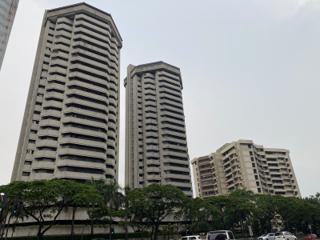 Three apartment buildings shot from a low angle.