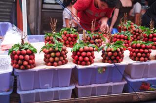 A woman at a booth selling ice cream shaped to look like fried chicken.