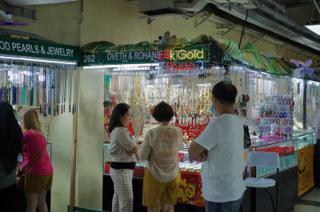 Shoppers at a jewelry stand consider their options.