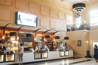 A high-ceilinged concession stand bathed in natural light.