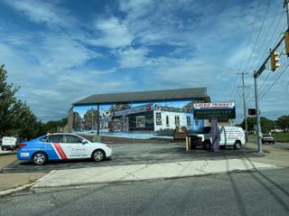A trompe-l'œil mural of a gas station on the wall of a gas station.