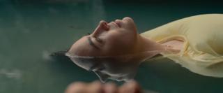 Layered shot with reflection in the water seeming to touch the foreground character’s face.