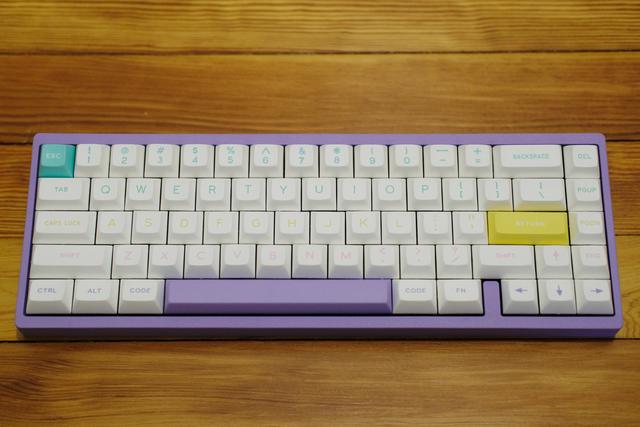 Top-down view of a keyboard with a lavender case and white keycaps.