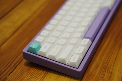 Closeup of the left-hand side of a keyboard, with a teal escape key in focus.