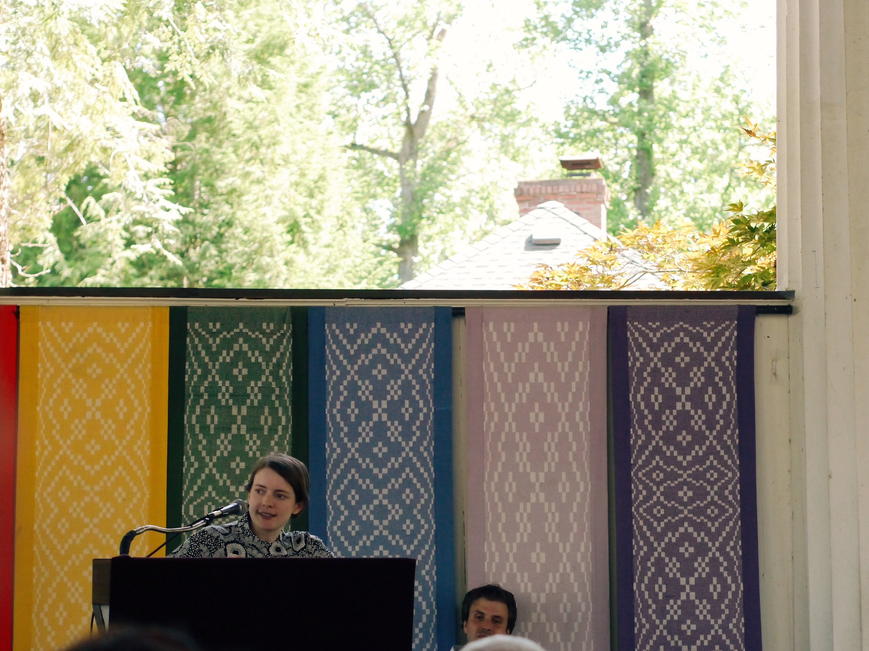 Emily St. John Mandel Author reading from a podium.