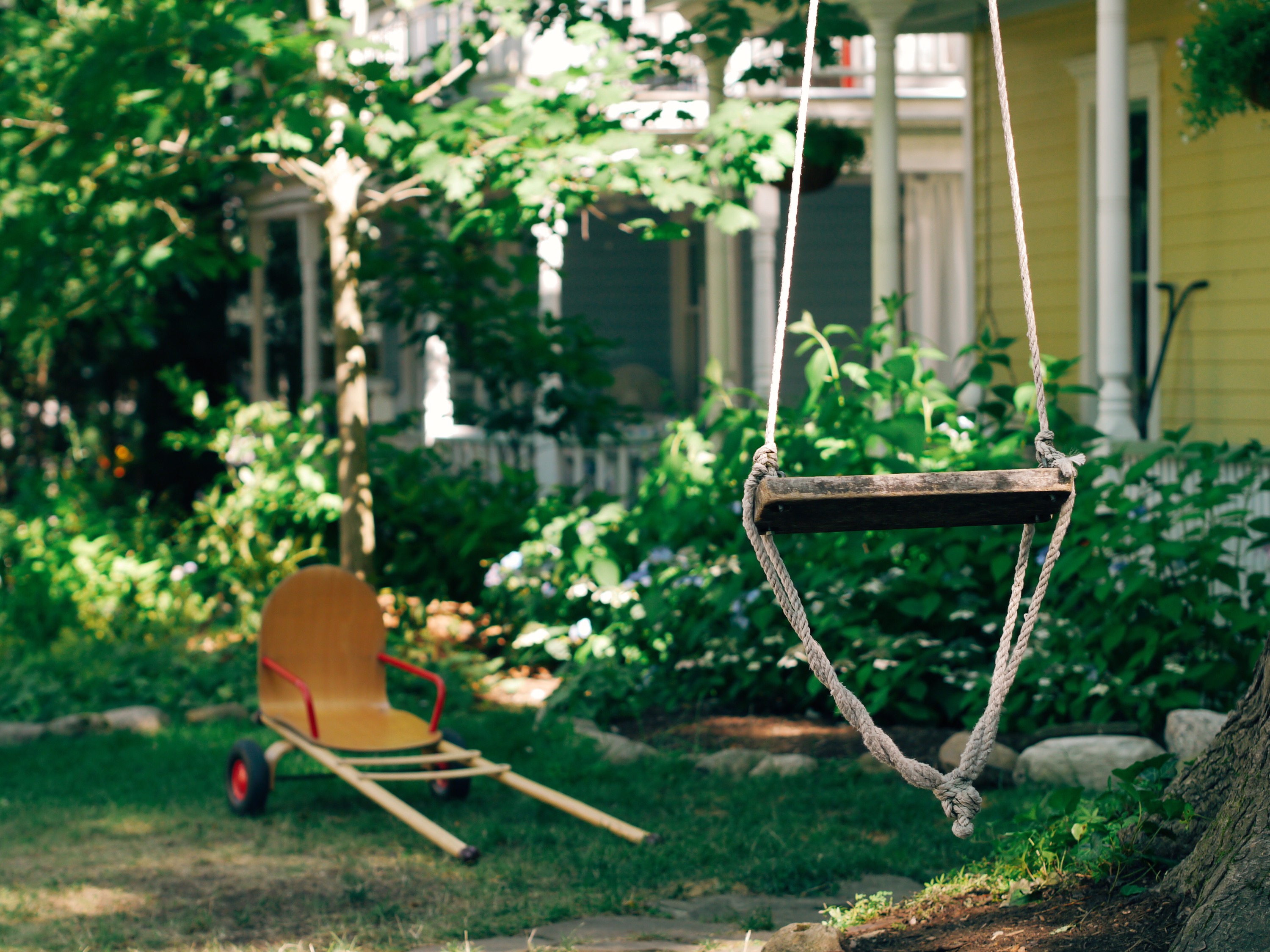 Porch Swing Swing in the foreground of a house.