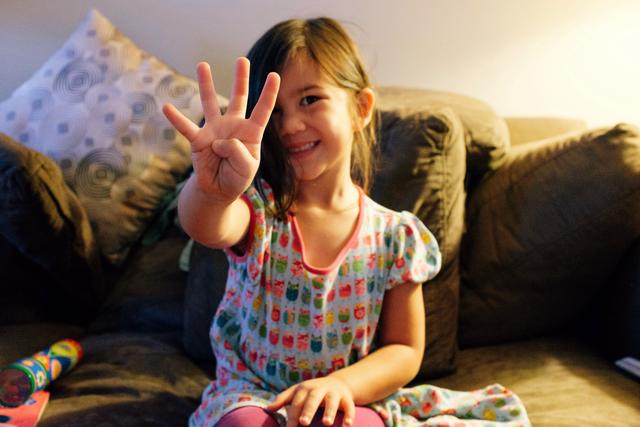 Girl holding up four fingers