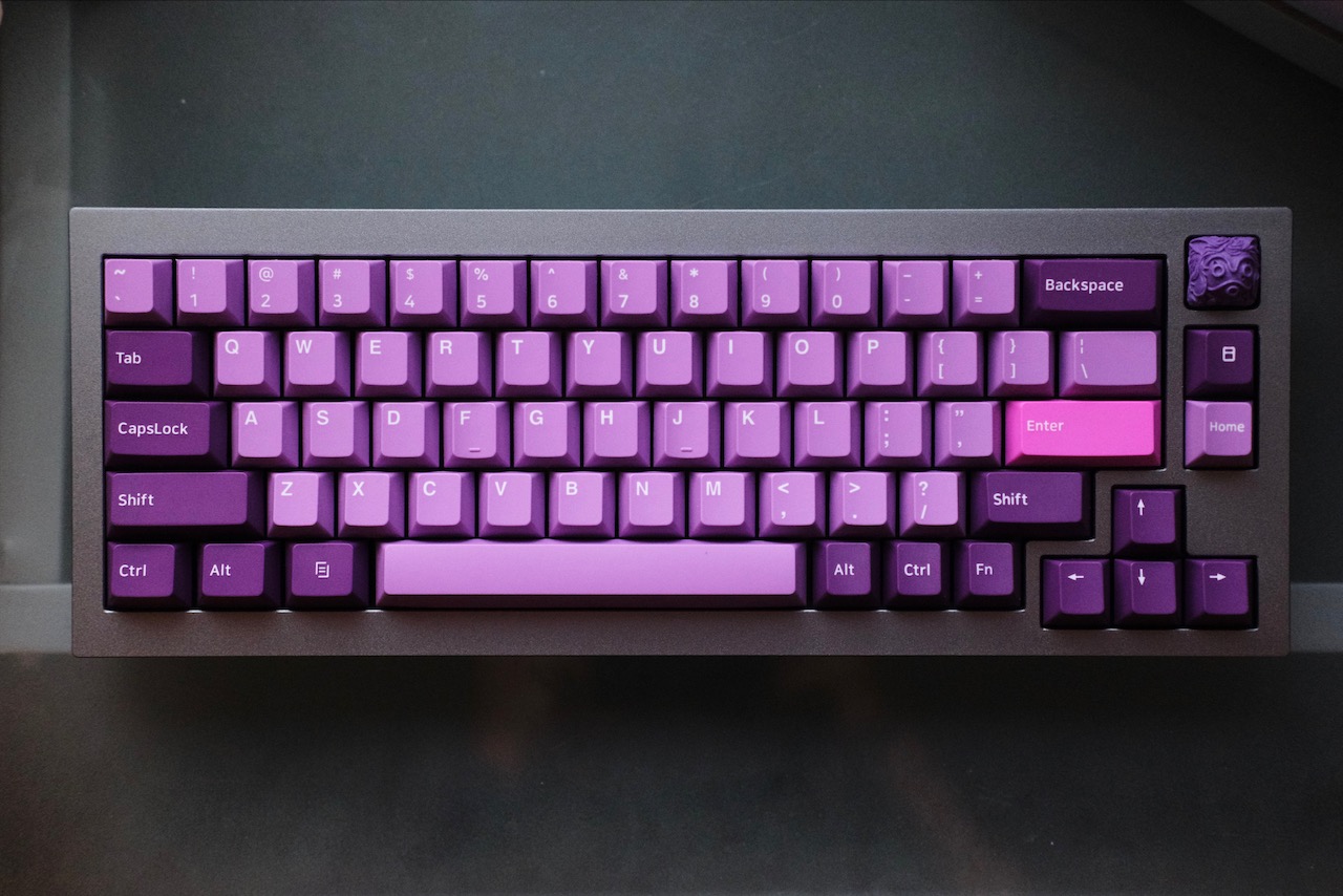 Fully built A top-down shot of a grey 65% keyboard white keyswitches.