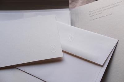 Embossed card and envelope laid on top of each other
