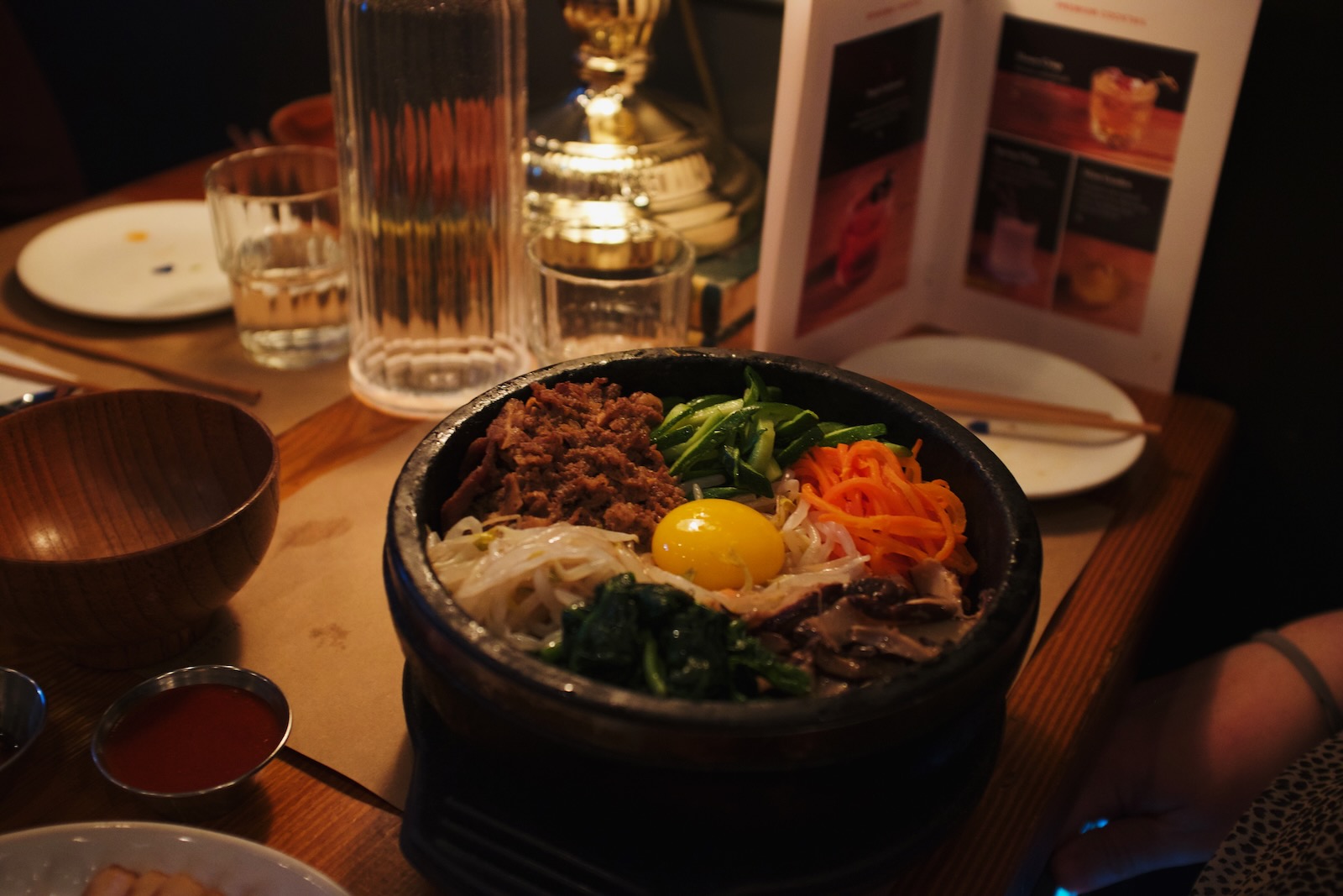 A bowl of bibimbap, with a single egg yolk perched perfectly in the center.
