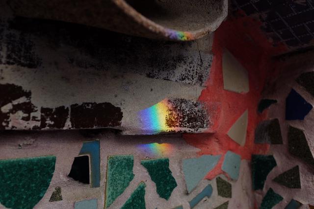 Rainbow reflection cast on a wall.