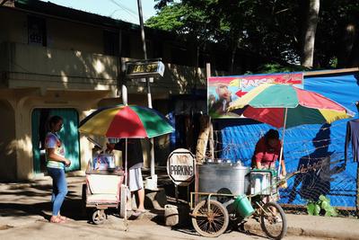 Street vendors for ice cream with multicolored umbrellas for shade.