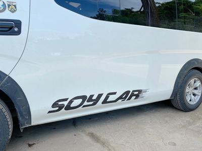 Side of a van with a decal reading “Soy Car”