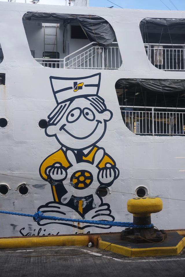 A cartoon sailor character painted on the side of a passenger ferry.