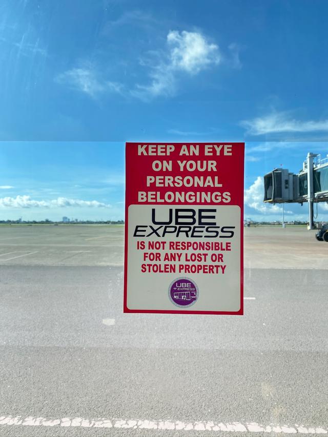 A sign for an airport shuttle named Ube Express.