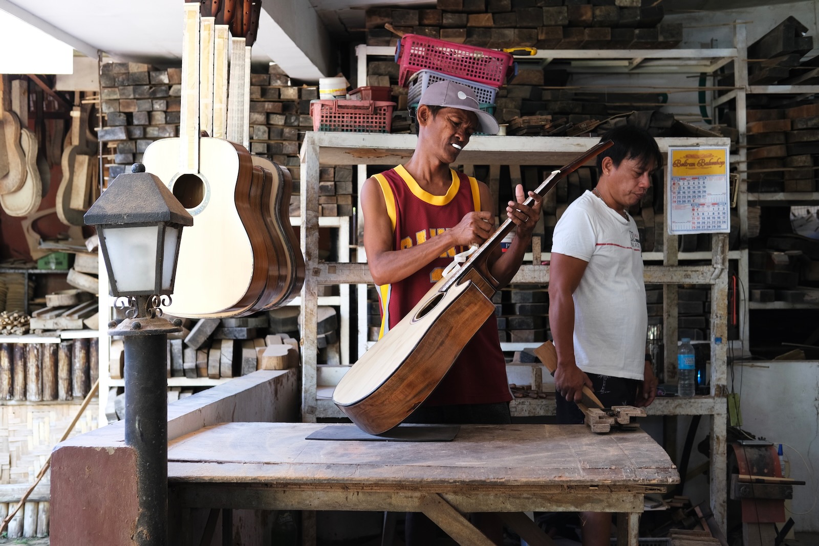 A man assembles a guitar.