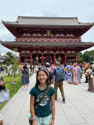 A girl smiles in front of Hōzōmon gate.