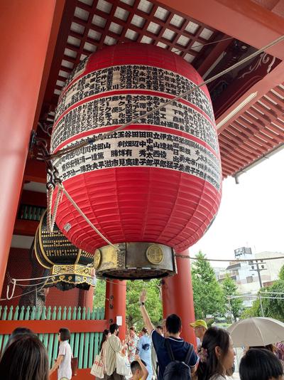 A large red lantern suspended from the ceiling of Hōzōmon.