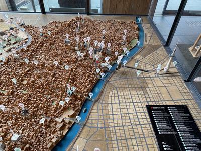 A 3D relief map of the Asakusa area, with a scale model of Tokyo Skytree and pins denoting points of interest.