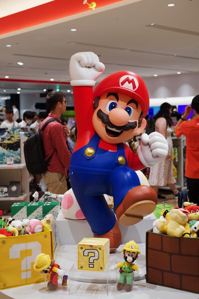 A giant figure of Super Mario in his classic jumping pose.