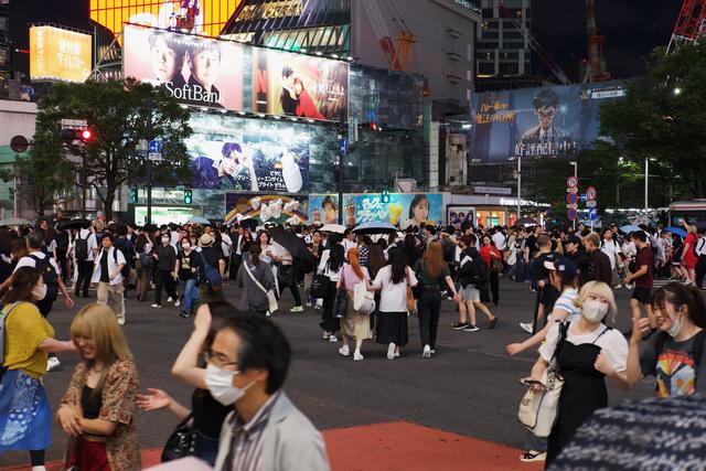 Streams of pedestrians in the center of the Shibuya Crossing.