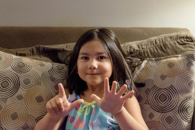 Amelia holding up seven fingers.
