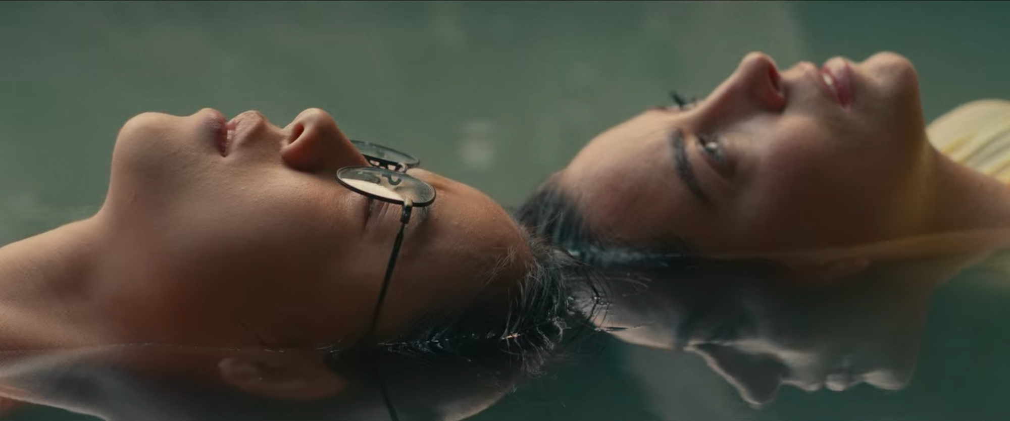 Image © Netflix. Two characters float in water, their heads appearing to touch.