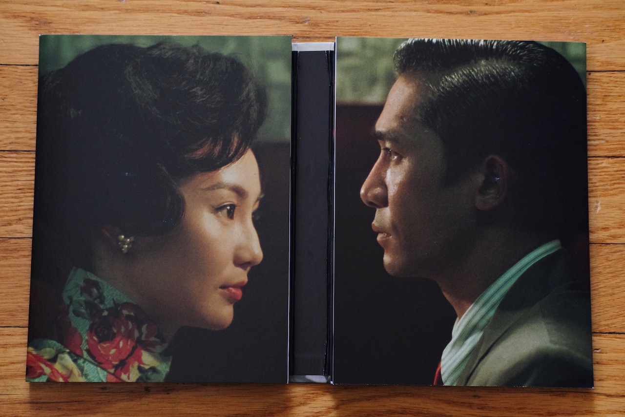 Booklet open to familiar faces Disc booklet open to two profile images of a man and woman facing each other.
